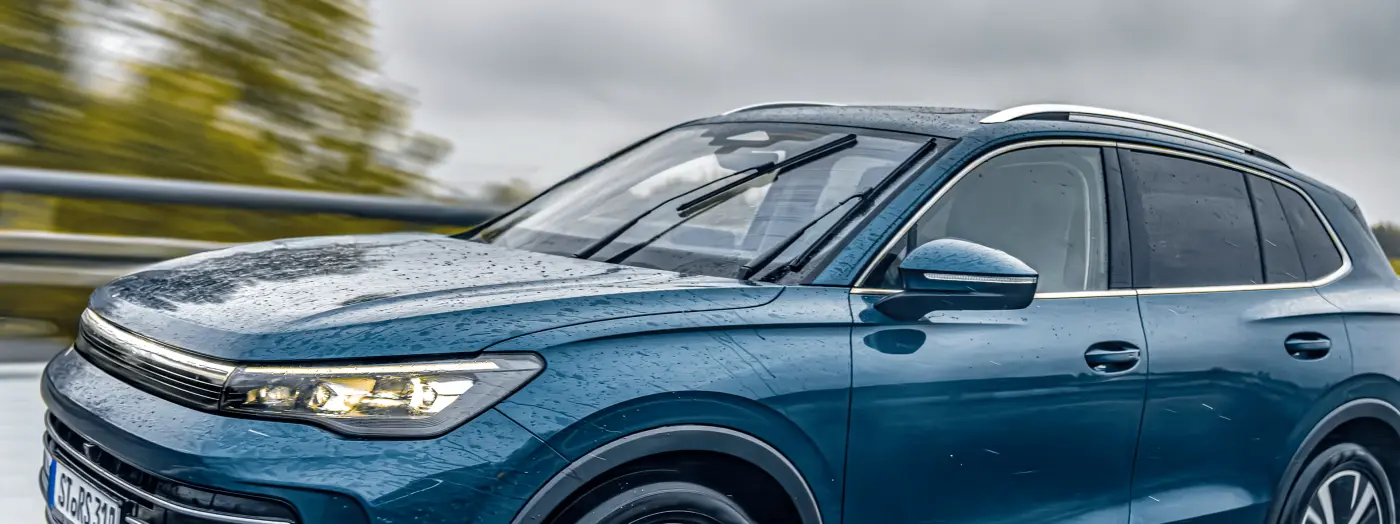 JAC JS6 premium crossover side profile view in motion on scenic highway modern design silver color