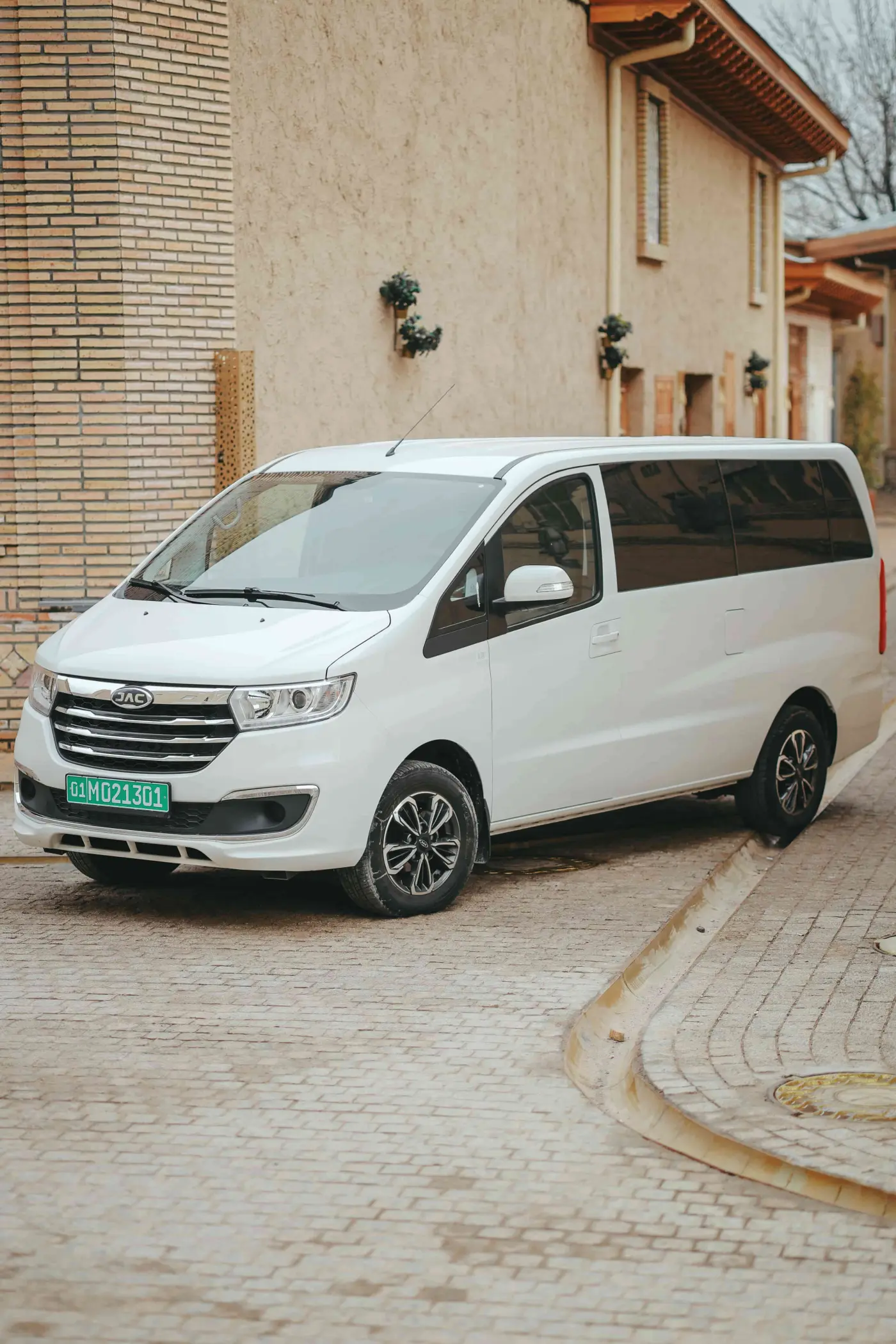 JAC JS6 premium luxury crossover SUV silver metallic color dramatic front 3/4 view on mountain road at sunset cinematic lighting epic landscape