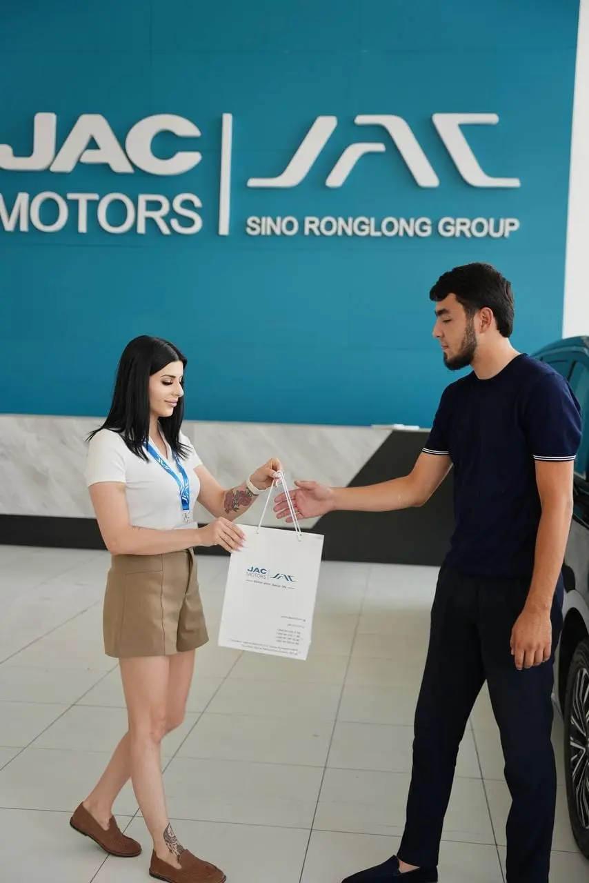 happy customer receiving car keys from sales representative handshake dealership professional service